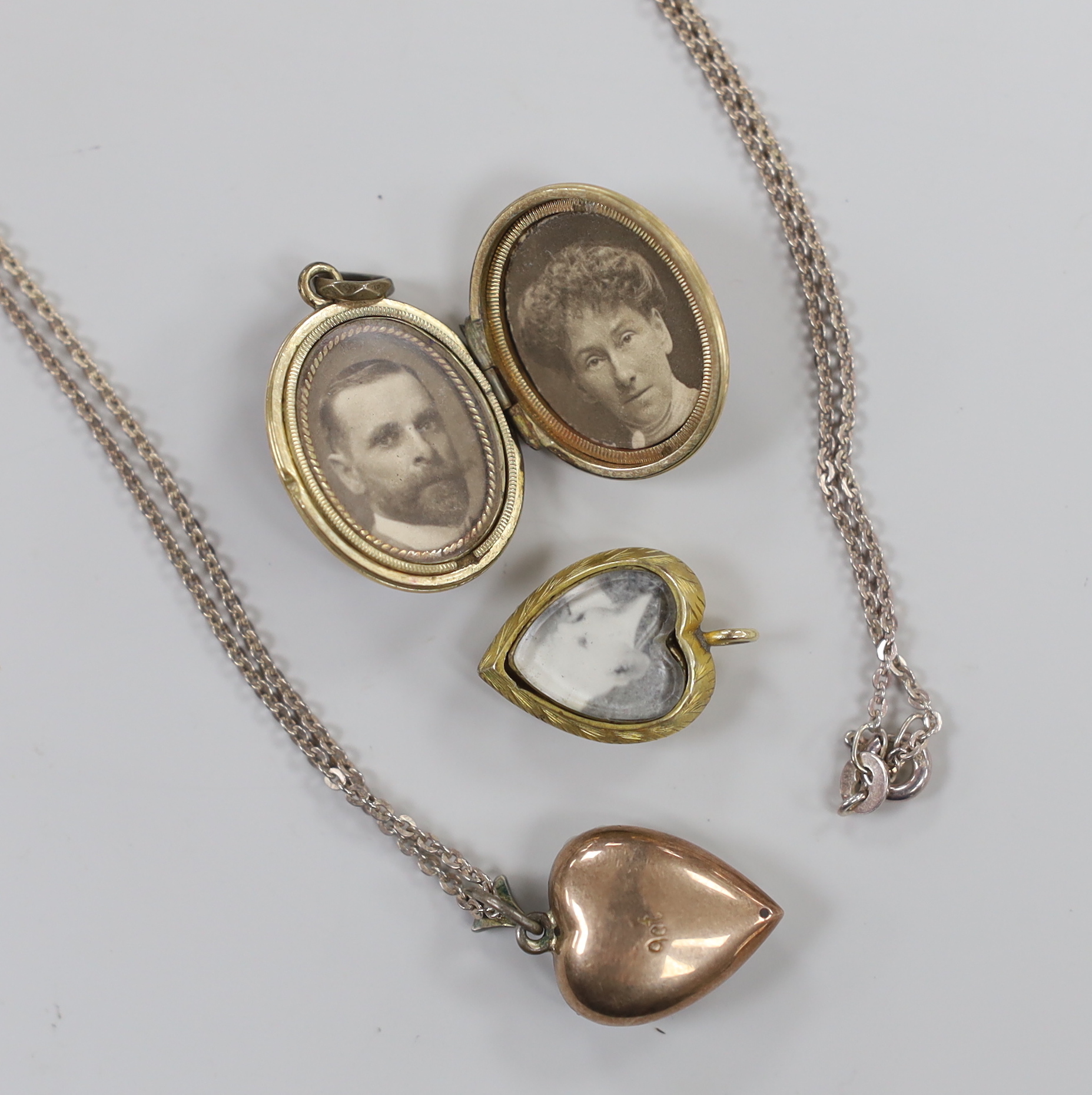 An early 20th century 9ct and seed pearl set heart shaped pendant, 16mm, on a later 925 chain, together with an enamelled locket and turquoise set heart shaped locket.